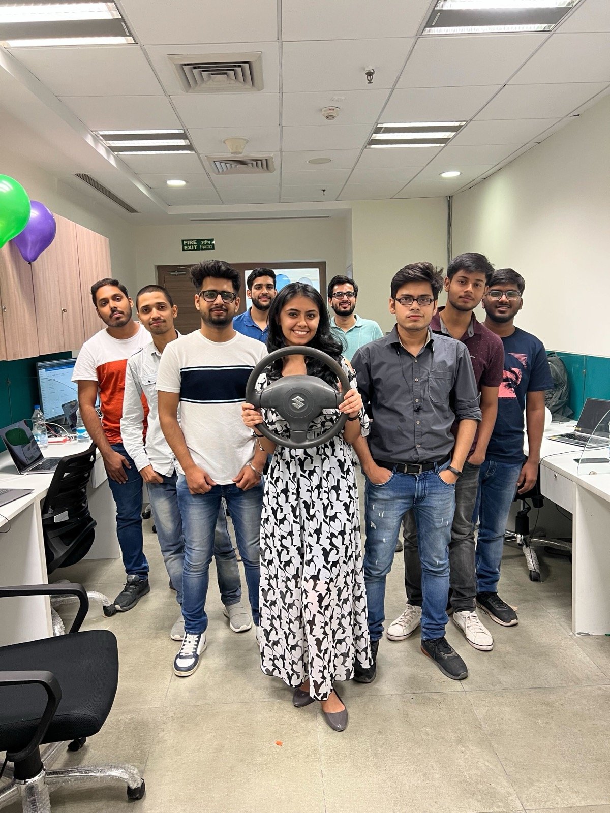 CarInfo team posing with steering wheel